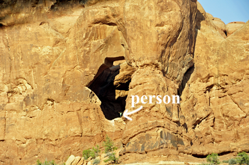 a person in the window of a cave
